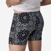 Close up back view of man wearing black bandana slim fit boxers & white t-shirt.